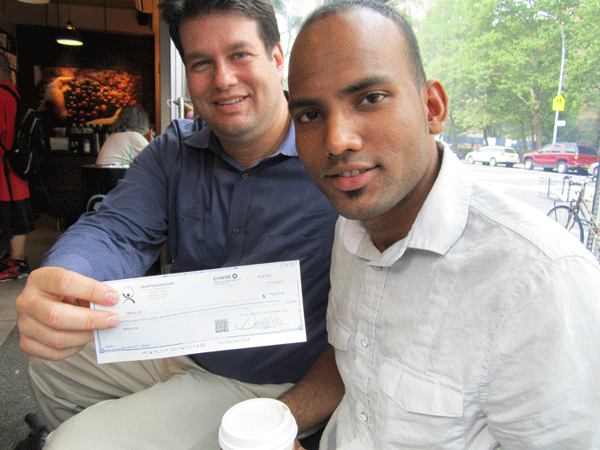 Photo by Lincoln Anderson Chad Marlow, rear, presented a check with the crowdsourcing funds to Akkas Ali’s son Rukanul Islam last Friday.