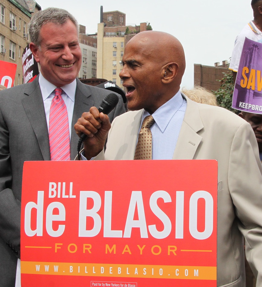 Mayoral candidate Bill de Blasio looked on as supporter Harry Belafonte spoke at a de Blasio rally on saving hospitals at the former St. Vincent's Hospital site on Monday.   Photo by Tequila Minsky