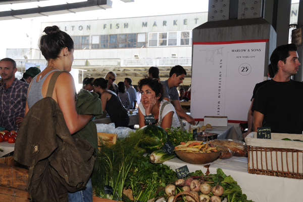 The city Landmarks Preservation Commission will not consider landmarking the New Market Building, seen here in the background as customers shopped at the New Amsterdam Market. Downtown Express file photo by Terese Loeb Kreuzer. 