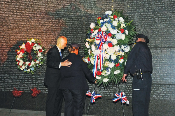 Downtown Express photo by Terese Loeb Kreuzer As he has done for the last 12 years, retired N.Y.P.D. Lieutenant Paul Putkowski led a service between midnight and 1 a.m. on Sept. 11 at the Police Memorial in Battery Park City, this year darkened by Superstorm Sandy. Most of those who attend are, or were, affiliated with the N.Y.P.D.’s 61st precinct in Sheepshead Bay.  