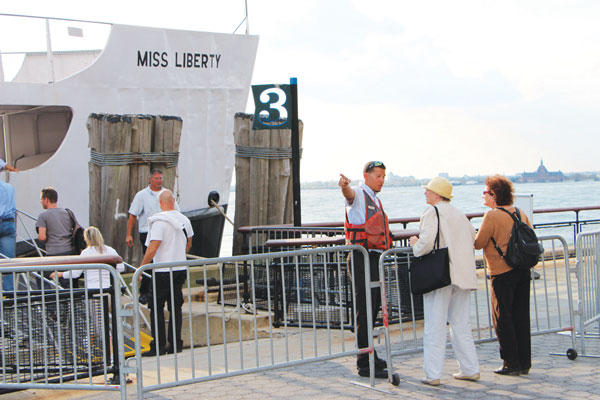 Downtown Express photo by Kaitlyn Meade Tourists were denied access to the Statue of Liberty last week. They were still showing up in Battery Park this week to visit Liberty and Ellis Islands, but some chose to exchange their tickets for a boat ride close to the statue. 