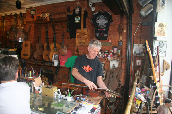 At Carmine Street Guitars, owner Tim Kelly does some repair work.