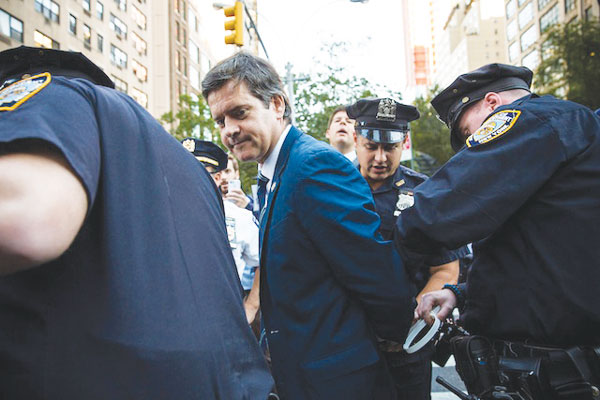 Brad Hoylman being led off in handcuffs at the U.N. on Wednesday.