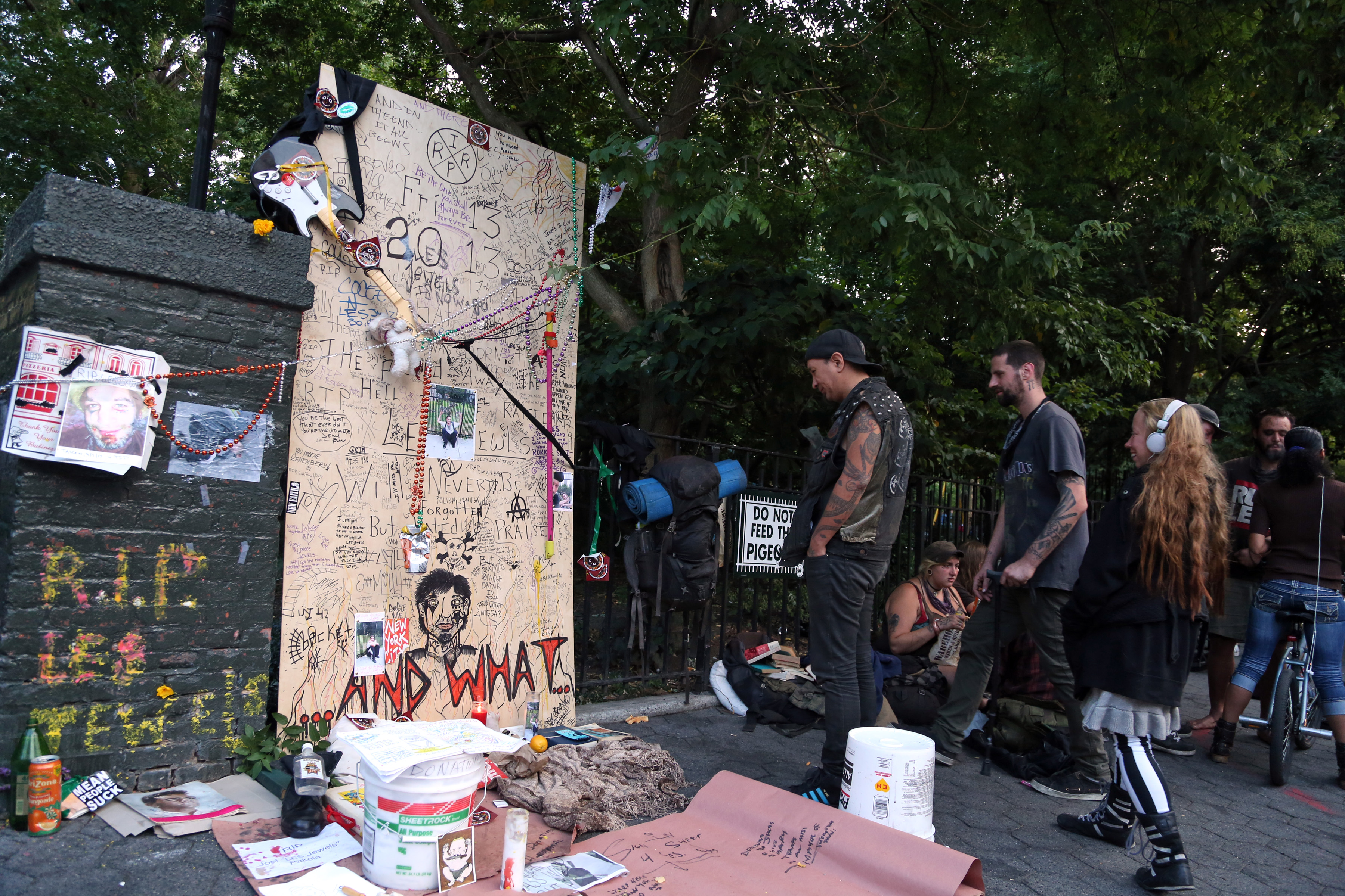 People stopping by the memorial to L.E.S. Jewels on Sunday.  Photo by Jefferson Siegel