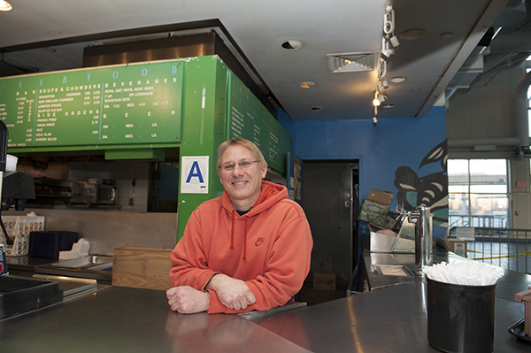 Joey Demane, whose family began selling fish at the Seaport in 1947, has the only business still open at Pier 17, which is slated to be demolished. Downtown Express photo by Terese Loeb Kreuzer. 