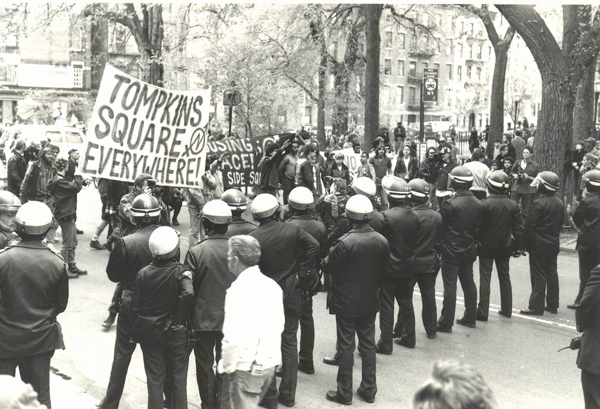 Riot police faced off with squatters and anarchist protesters in Tompkins Square in the 1980s. The protesters demanded that the sprawling Tent City in the park remain until the city housed the homeless. There were frequent clashes with police, the biggest being the 1988 riot over a curfew for the park. Under Mayor Dinkins the Tent City was evicted and the park closed for renovations. BROOKLYN COLLEGE LIBRARY ARCHIVES / PHOTO BY BETSY HERZOG