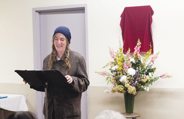 Photos by William Alatriste  At left, Patti Smith, who knew Lucy Cecere as a dear friend from the neighborhood, spoke before the unveiling. At right, friends of Cecere’s admired the new plaque.