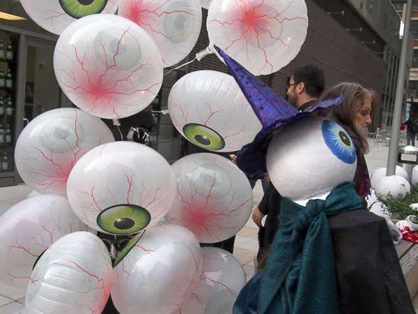 “I of the Beholder” was the theme of the 2011 Greenwich Village Halloween Parade, inspired by French surrealist painter Odilon Redon’s “Eye Balloon” —— hence the eyeball balloons. The 2012 parade was canceled in the wake of Superstorm Sandy. A marcher in the 2010 Greenwich Village Halloween Parade, right, portrayed Gede, the Haitian Vodou goddess, who is a protector of graves in cemeteries.