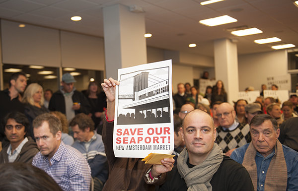 Some attendees came with protest signs.. Downtown Express photo by Terese Loeb Kreuzer.