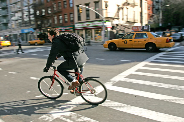 Penn South Pedestrians Want Better Bike Lane Safety 2 Photo by Sam Spokony A bicyclist zips along Eighth Ave. before turning left onto W. 25th St. Penn South residents who frequently walk across that intersection want DOT to install a special stoplight to control the flow of turning bikes and cars.