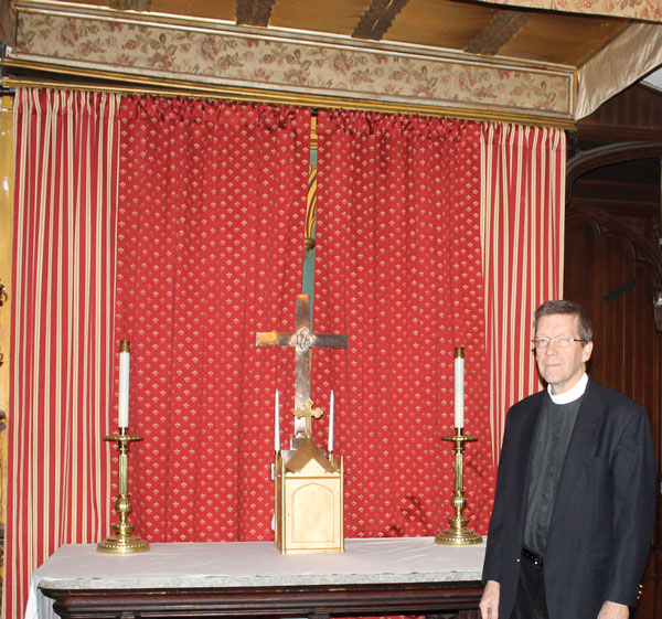 Photo courtesy of St. Peter’s Pay attention to that man beside the brocade curtain: Fr. Harding preps for the big reveal — at St. Peter’s, on Nov. 10.