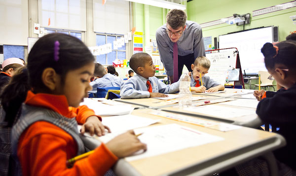 Teacher John Kaufmann working with first graders at Success Academy Union Square.  Photo by Byron Smith