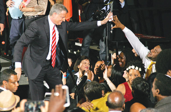 Bill de Blasio reached out to give a supporter a high-five at his election night celebration in Brooklyn.  Photo by Sam Spokony