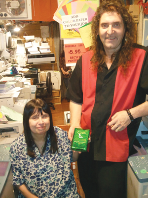 Santo Mollica, holding E.V.C.C. Outstanding Pigeon Award, and Margaret Mollica at their The Source Unltd store in the East Village. PHOTO BY HEATHER DUBIN