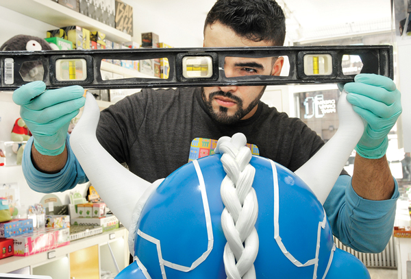 Victor De Los Angeles checking the 3D-printed horns that he had just applied to his creation.  Photos by Bob Krasner