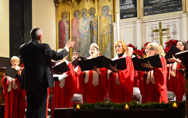 From 2012: Larry Long directs the Chelsea Community Church Candlelight Carol Service choir. The annual service happens this year on Dec. 15.    PHOTO BY CHRIS KREUSSLING (FLATBUSH GARDNER)