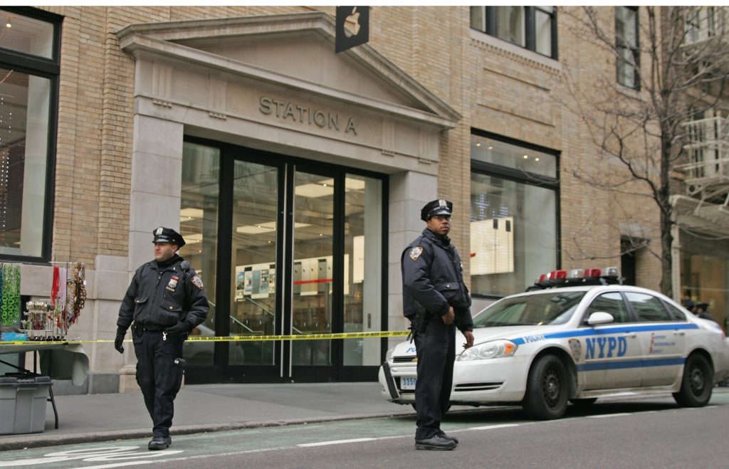 Police block off and guard the entrance to the Soho Apple Store following the bomb threat.