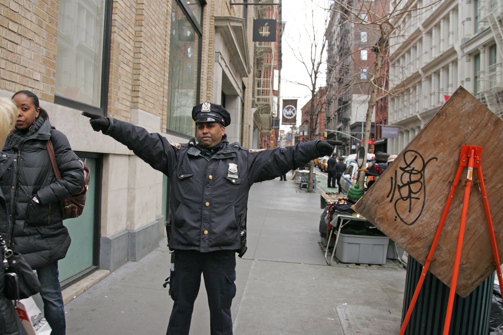 Before police cordoned off the sidewalk in front of the store, an officer directed pedestrians away from the location.