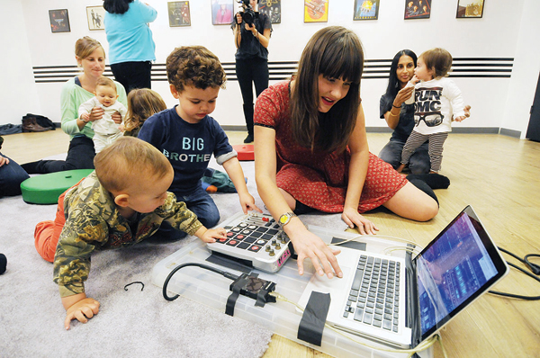 Babies and Natalie Weiss get down to the business of beats at the Baby DJ School.   Photos by Jonathan Alpeyrie