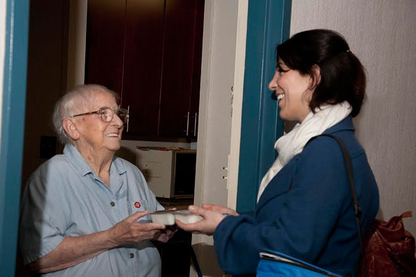 A Citymeals-on-Wheels volunteer recently delivering a hot meal to a local senior. During Thanksgiving, the volunteers also handed out specially designed placemats from the District Attorney’s Elder Abuse Unit sporting phone numbers for seniors to call to report any abusive behavior toward them.