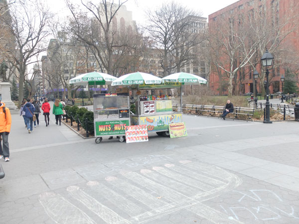 There was one hot dog vendor in Washington Square Park this Wednesday. He said he didn’t speak English, and declined to be in the photo. The Parks Department plans to move the hot dog carts out of the park by the end of this month.  Photo by Pasha Farmanara