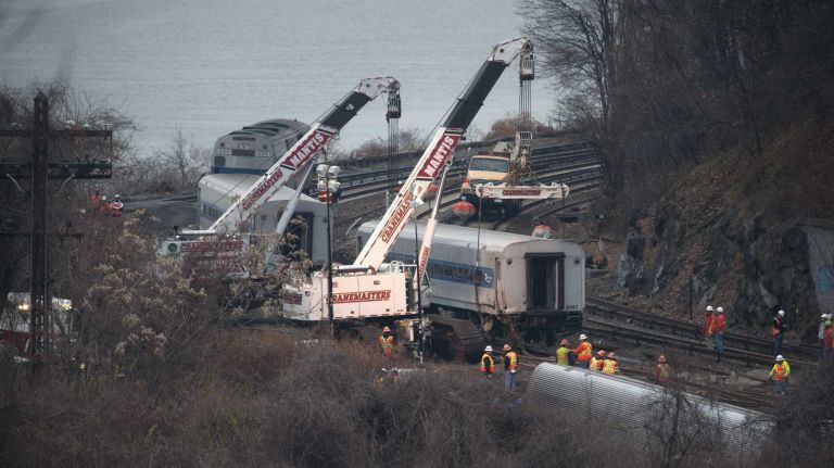 Cranes are used to right derailed Metro-North train cars at the scene of the fatal accident in the Bronx. (Dec. 2, 2013)