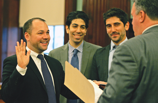 Corey Johnson, far left, was sworn in on Dec. 27 as the new District Three city councilmember, as two of his top aides, Louis Cholden-Brown, center, and R.J. Jordan, looked on. Until this past week, it was thought Jordan — who managed Johnson's campaign — would be his chief of staff. Photo by Sam Spokony