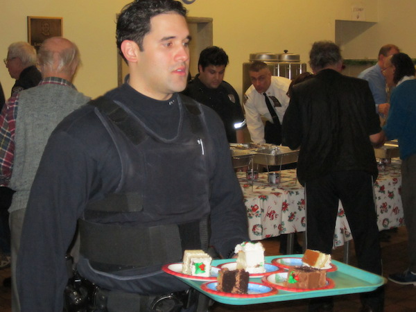 A Sixth Precinct officer serving dessert at last year's Police Roast Beef Dinner.