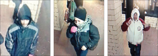 Police surveillance images of the three suspects in a Nov. 23 mugging in a lobby entrance at Henry and Clinton Sts.
