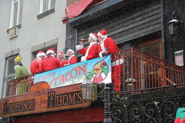 Professor Thom’s, on Second Ave. between 13th and 14th Sts., had the welcome mat — and balcony — out for SantaCon last Saturday. Photo by Jefferson Siegel