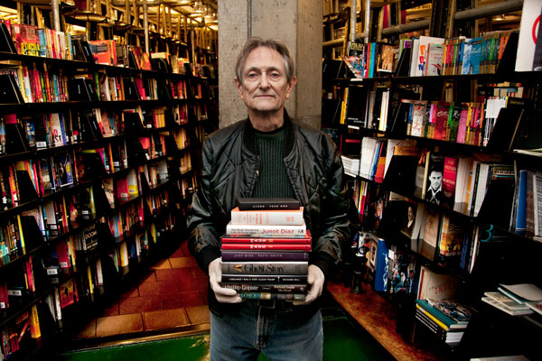 ‘Maus’…going once, going twice!... 2 St. Mark’s Bookshop co-owner Terry McCoy, wearing protective gloves, holds several of the books to be auctioned this Thursday. Art Spiegelman’s “Maus” has the highest reserve — the starting price below which bids won’t be accepted. Photo by Bob krasner