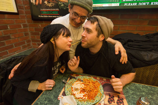 Staged love, Disney-style: At Rosario’s, Sal helps Rev. Jen and Courtney reenact an iconic scene from “Lady and the Tramp.”   PHOTO BY WALTER WLODARCZYK