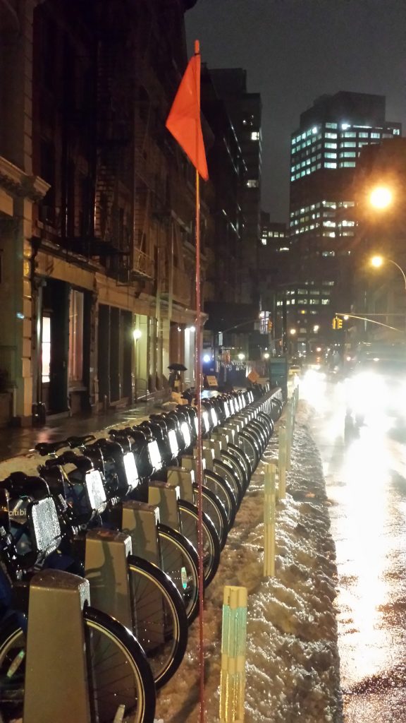 A "station identification" flag was placed at the bike-share dock at Grand and Greene Sts. after winter storm Hercules — just in case anyone couldn't recognized that there were bikes here.  Photo by Scoopy