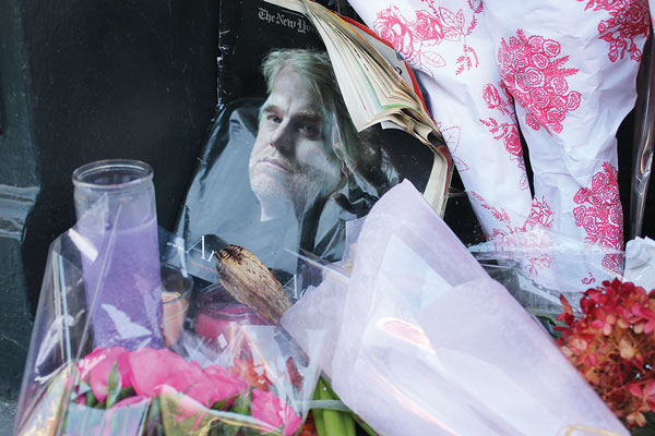 A memorial to Philip Seymour Hoffman outside 35 Bethune St. included a Dec. 21, 2008, New York Times Magazine with a cover article, “Portrait of an Artist as an Actor’s Actor,” on Hoffman.   Photo by Lincoln Anderson