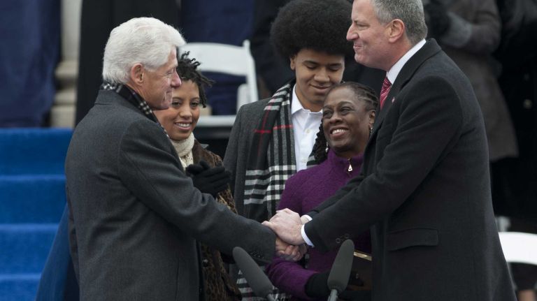Former President Bill Clinton shakes hands with Mayor Bill de Blasio after administering the oath of office during a ceremony outside of City Hall on Wednesday in Manhattan. de Blasio, the first Democratic mayor in two decades, has promised a new era of progressive leadership. (January 01, 2014).