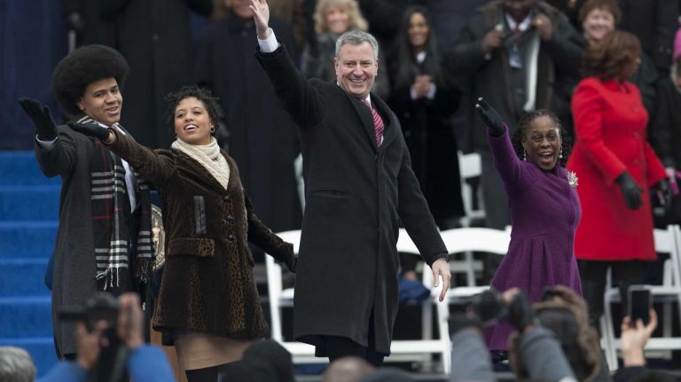 Bill de Blasio is joined by his wife Chirlane McCray, son Dante, and daughter Chiara to blow kisses to audience members after taking the oath of office becoming the109th Mayor of New York City during a ceremony outside of City Hall in Manhattan on Jan. 1, 2014.