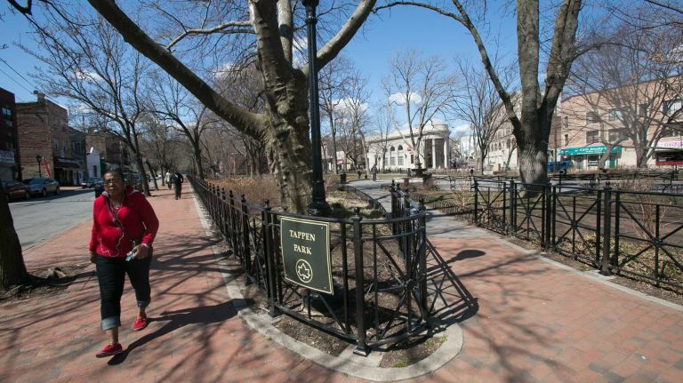 A woman walks along the path in Tappen Park in the St. George/Stapleton neighborhood. (Mar. 30, 2013)