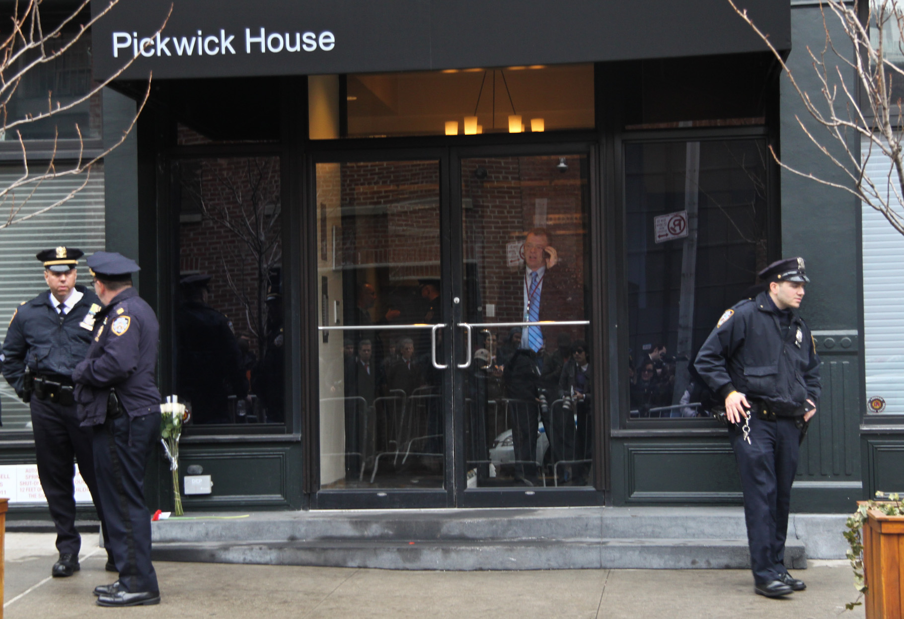 Police guarded the building, letting only residents and other police and medical officials in and out.  Photo by Tequila Minsky