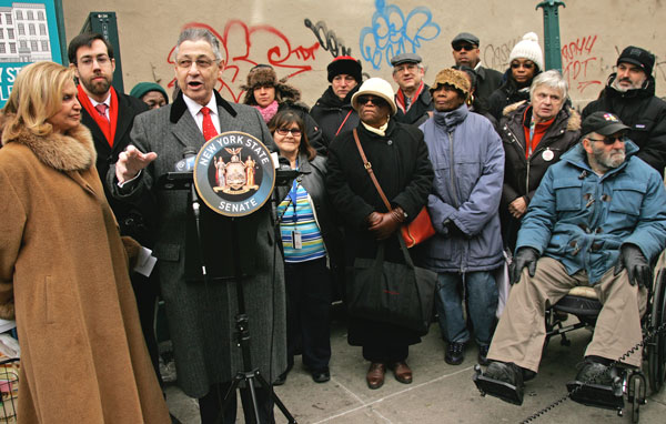 L.E.S. seniors demand M.T.A. get moving and fix escalator 1 Assembly Speaker Sheldon Silver (at podium), along with Congressmember Carolyn Maloney and state Senator Daniel Squadron (standing to the left of Silver), urged the M.T.A. to finally finish its work on the East Broadway subway escalator. Photo by Sam Spokony