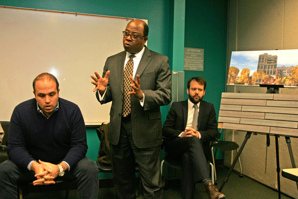 Residents: New Condo Building will ‘Violate the Culture’ of Their Block 2 Daniel Nicolas, a French Evangelical Church board trustee (standing), flanked by developer Yiannes Einhorn (left) and architect Steven Wakenshaw, took heated criticism from W. 16th St. residents at the March 6 meeting. Photo by Sam Spokony