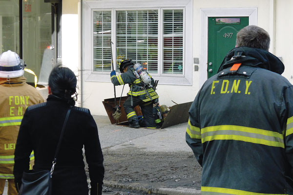 Firefighters checked out a Canal St. building’s basement after an electrical fire ignited flames.  Photo by Sam Spokony