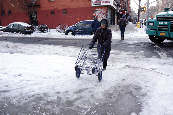 Even directly in front of P.S.A. 4, the Housing Police station at 130 Avenue C, the police, at least initially, did not bother to shovel or salt the sidewalk curb cuts last week.   Photos by Sarah Ferguson