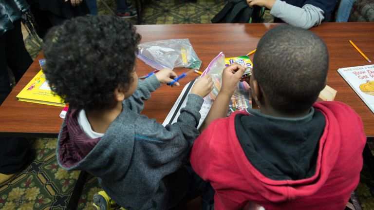 Students work together in a makeshift classroom at a homeless shelter in Commack on Feb. 12, 2014.