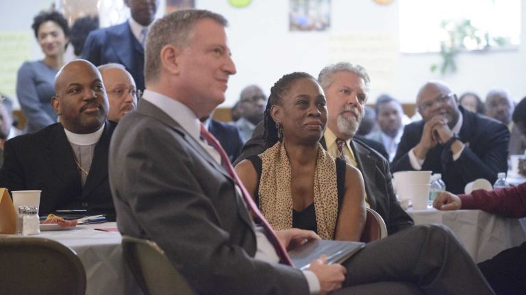 New York City Mayor Bill de Blasio, second from right, his wife Chirlane McCray, center, Bishop Orlando Findlayter, seated left, and others listen as the Reverend Al Sharpton delivers remarks to clergy during a breakfast in support of de Blasio's Universal Pre-K plan at Bethany Baptist Church on Feb. 11, 2014.