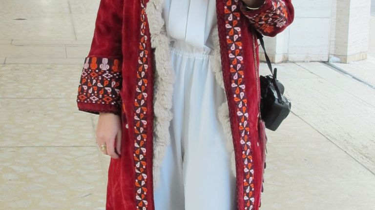 An exotic coat brings flair to a simple jumpsuit.