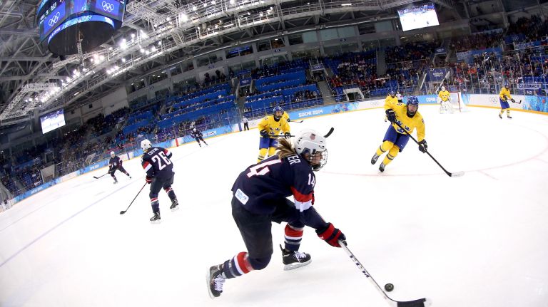 Brianna Decker #14 of the United States handles the puck in the third period against Sweden during the women's ice hockey playoffs semifinal game on day ten of the Sochi 2014 Winter Olympics at Shayba Arena on Monday, Feb. 17, 2014.