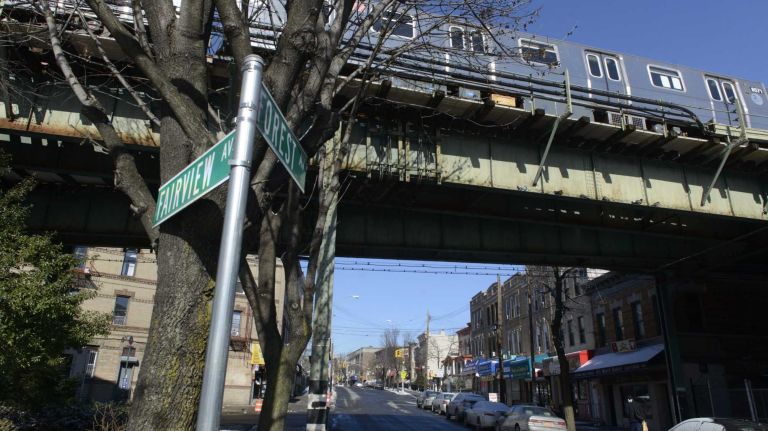 A M train passes over Forest Avenue. 