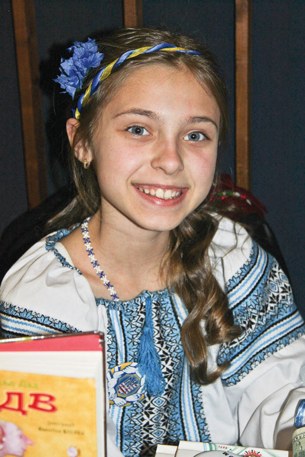 A girl in traditional Ukrainian dress manned a book table at the Razom fundraiser.