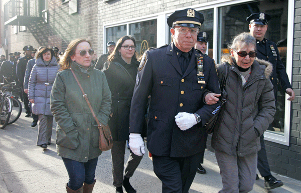 Longtime Auxiliary Police Officer Maury Englander walked with Iola Latman, the mother of Nicholas Pekearo, to the March 14 memorial.  