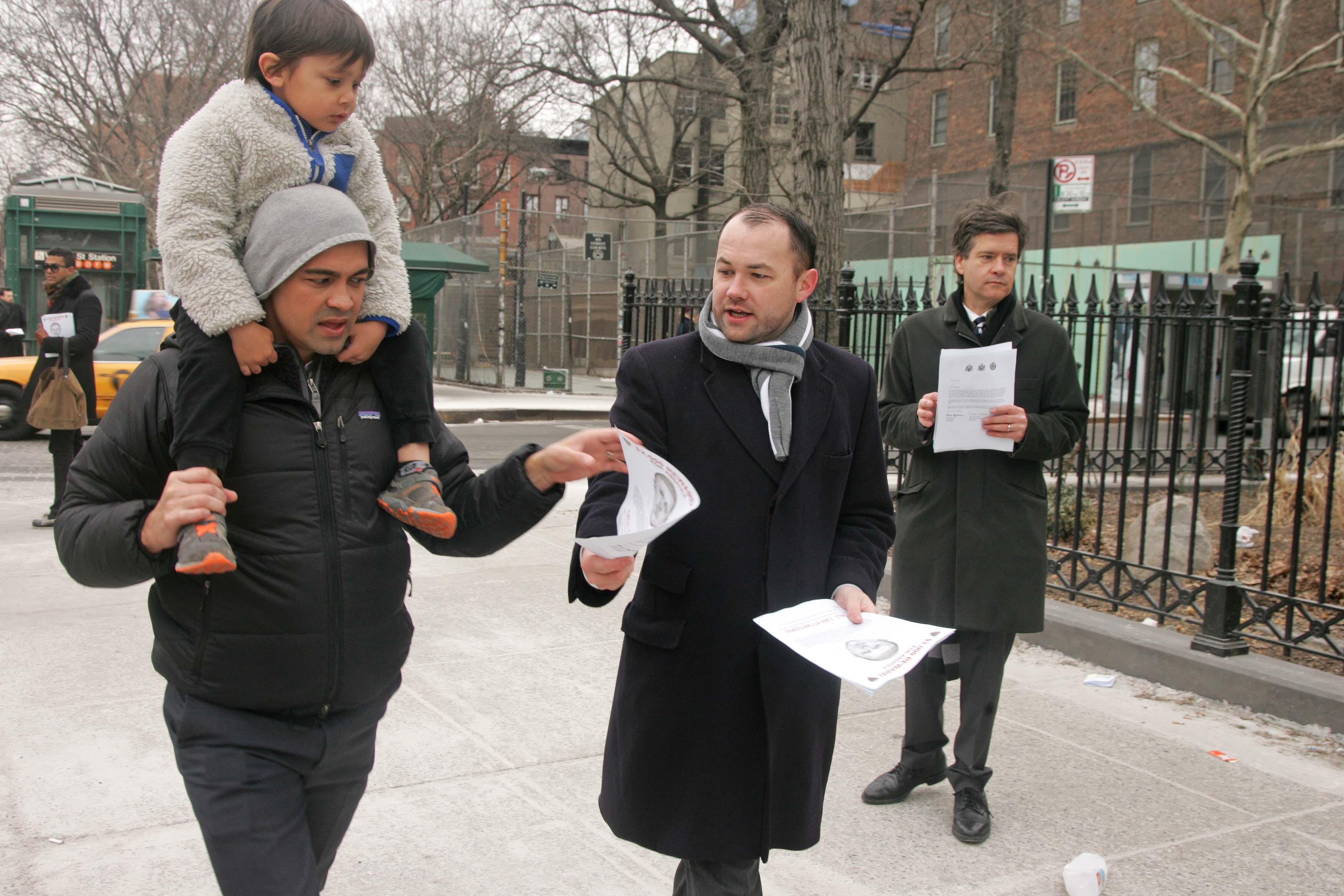 City Councilmember Corey Johnson, center, and state Senator Brad Hoylman, right, handed out fliers with the suspect's police sketch near the W. Fourth St. subway station on Friday morning.  Photo by Sam Spokony